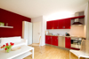 Ferienwohnung Auszeit im Ostseebad Ahrenshoop - Wohnbereich mit Kamin und Einbauküche, sowie Essplatz